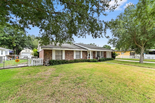 2104 S 26th St, Fort Pierce, FL 34947 - ranch-style home featuring brick siding, an outbuilding, and a gate