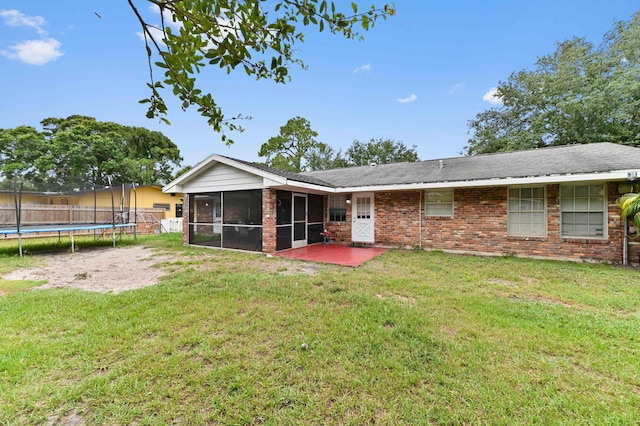 2104 S 26th St, Fort Pierce, FL 34947 - rear view of house with a sunroom, a trampoline, a patio area, and brick siding