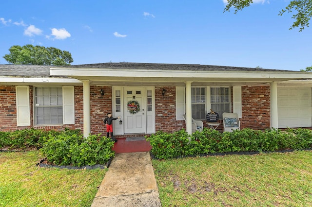 2104 S 26th St, Fort Pierce, FL 34947 - ranch-style home with brick siding, an attached garage, and a porch