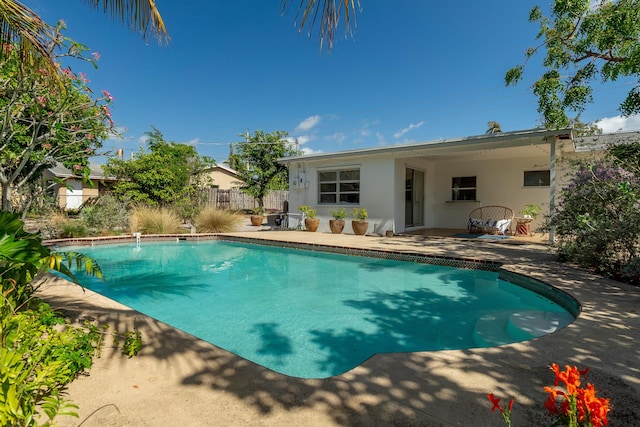 view of pool with a fenced in pool, fence, and a patio