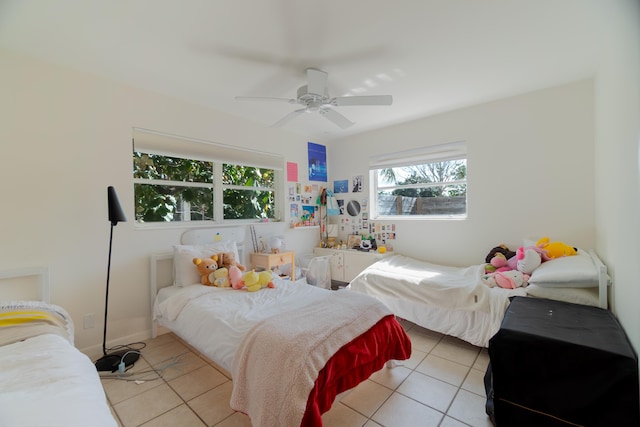 tiled bedroom featuring ceiling fan