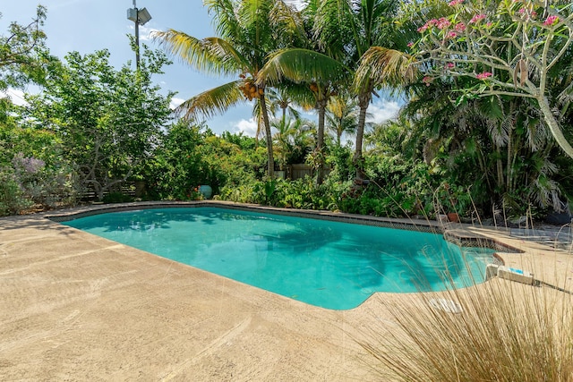 pool with fence and a patio area