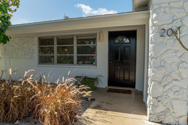 entrance to property featuring stone siding