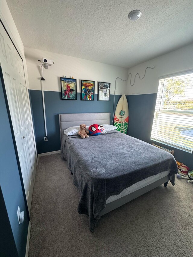 133SW SW Becker Rd, Port Saint Lucie, FL 34953 - bedroom featuring carpet floors, a textured ceiling, and a closet