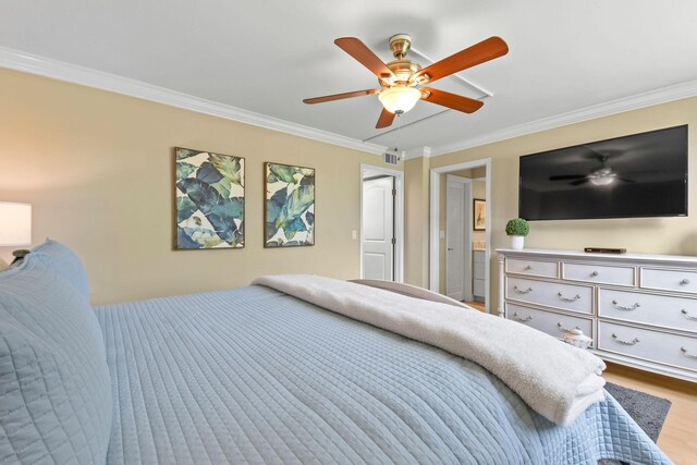 bedroom featuring visible vents, ornamental molding, ceiling fan, and wood finished floors