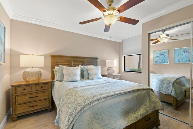 bedroom with crown molding, baseboards, ceiling fan, and light wood-style flooring