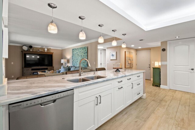 kitchen with a sink, dishwasher, light wood-style flooring, white cabinetry, and ornamental molding