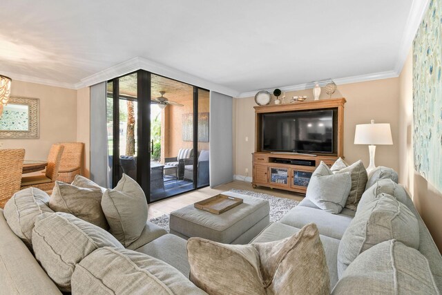 living area featuring crown molding, baseboards, and wood finished floors