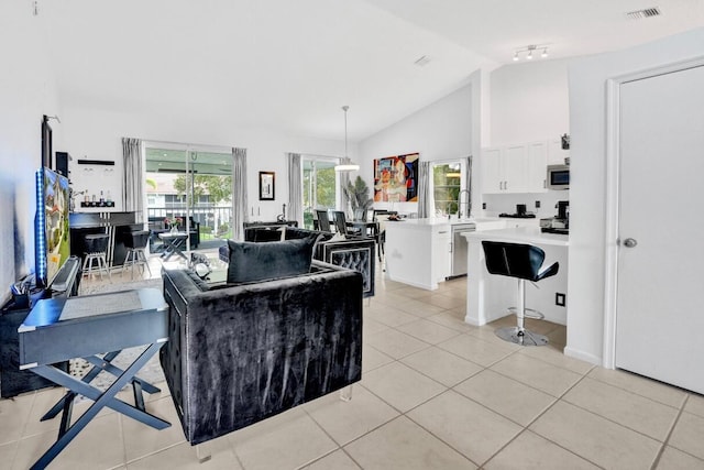 7669 Springwater Pl Unit 202, Boynton Beach, FL 33437 - living room featuring light tile patterned floors, high vaulted ceiling, and visible vents
