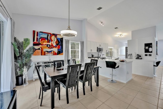7669 Springwater Pl Unit 202, Boynton Beach, FL 33437 - dining room with light tile patterned floors, high vaulted ceiling, baseboards, and visible vents
