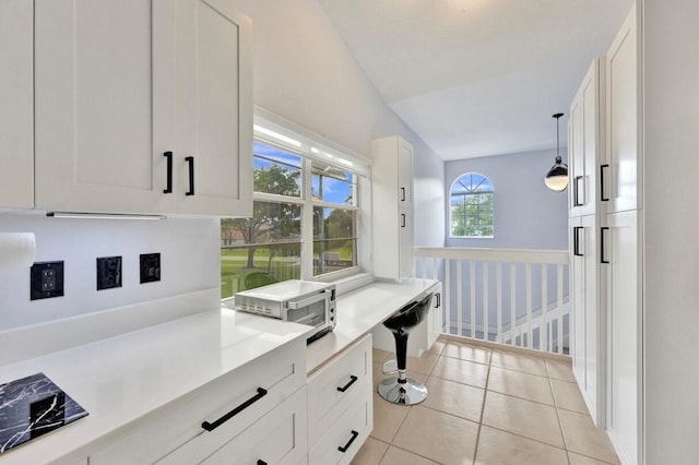 7669 Springwater Pl Unit 202, Boynton Beach, FL 33437 - kitchen with light countertops, white cabinets, light tile patterned floors, and hanging light fixtures