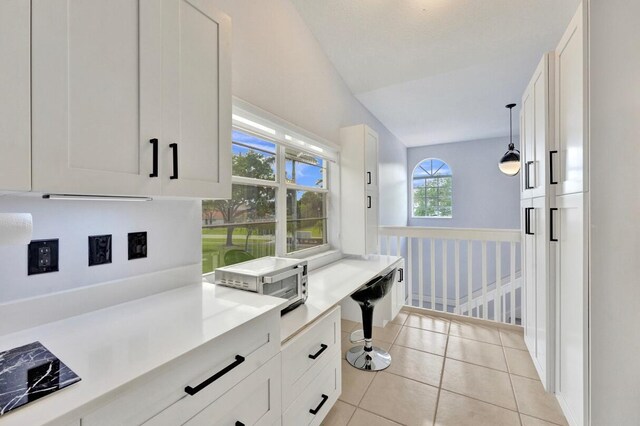 7669 Springwater Pl Unit 202, Boynton Beach, FL 33437 - interior space featuring a toaster, light countertops, white cabinetry, light tile patterned floors, and decorative light fixtures