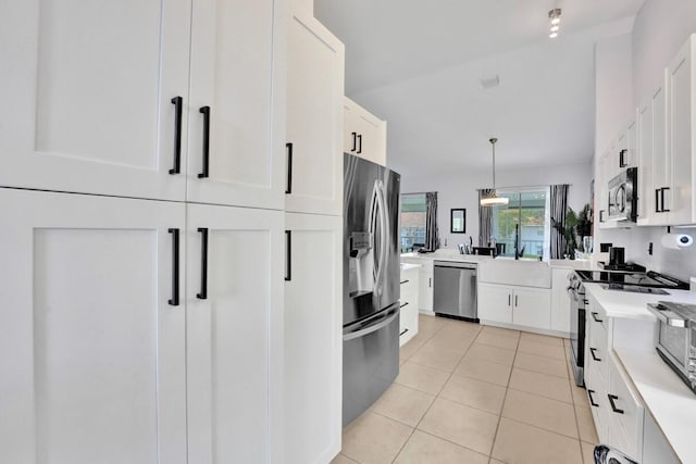 7669 Springwater Pl Unit 202, Boynton Beach, FL 33437 - kitchen featuring light countertops, appliances with stainless steel finishes, white cabinetry, and a sink