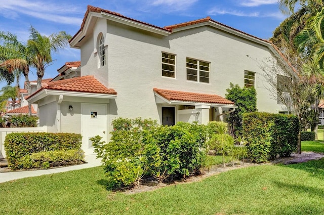 7669 Springwater Pl Unit 202, Boynton Beach, FL 33437 - view of front facade featuring a tiled roof, a front yard, and stucco siding