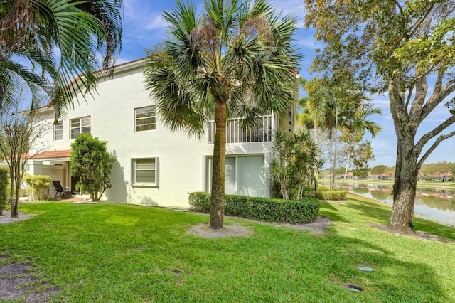 7669 Springwater Pl Unit 202, Boynton Beach, FL 33437 - exterior space with a water view, stucco siding, and a yard