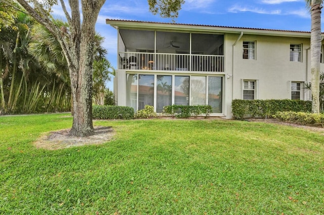 7669 Springwater Pl Unit 202, Boynton Beach, FL 33437 - rear view of property featuring a sunroom, stucco siding, a yard, and ceiling fan