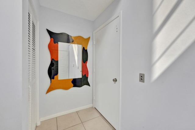 7669 Springwater Pl Unit 202, Boynton Beach, FL 33437 - corridor featuring baseboards and tile patterned floors