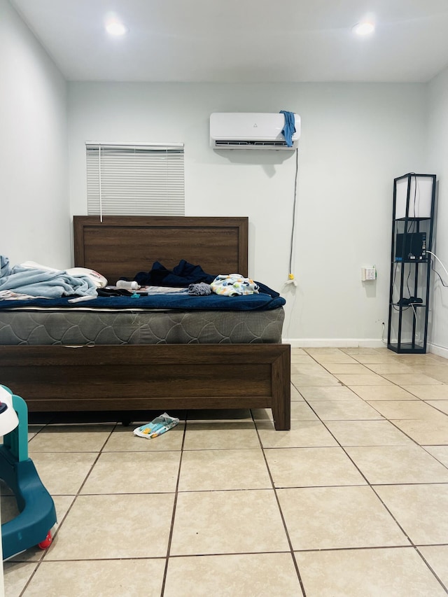 bedroom with an AC wall unit, baseboards, recessed lighting, and light tile patterned floors