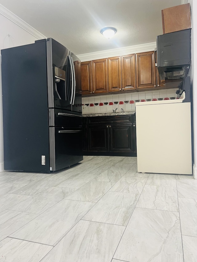kitchen with stainless steel fridge and ornamental molding