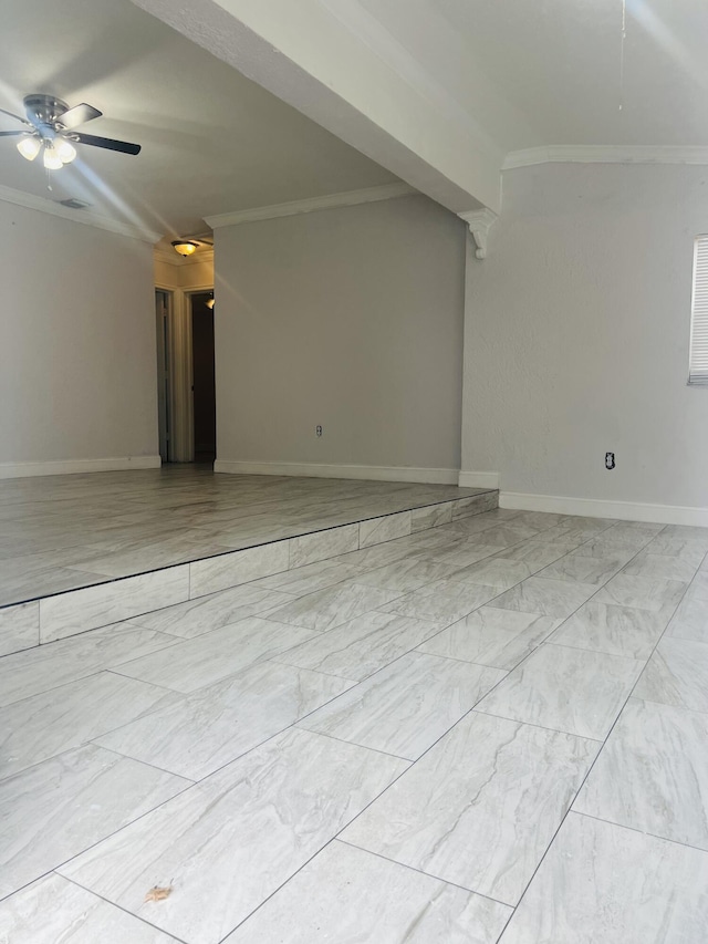 empty room featuring baseboards, ornamental molding, ceiling fan, and marble finish floor