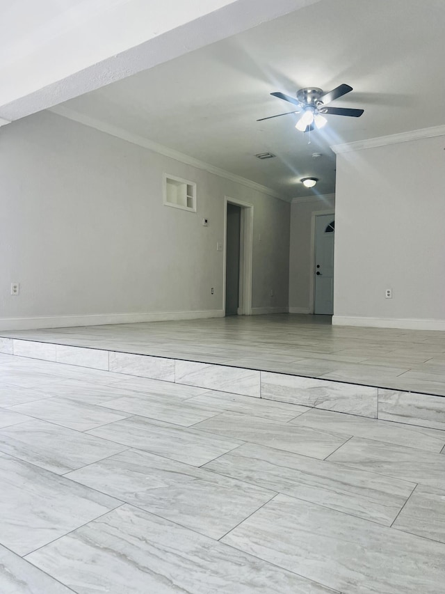 spare room with baseboards, ornamental molding, ceiling fan, and marble finish floor