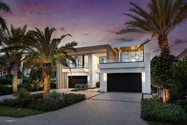 217 Thatch Palm Dr, Boca Raton, FL 33432 - view of front of home with a balcony, decorative driveway, stucco siding, and a garage
