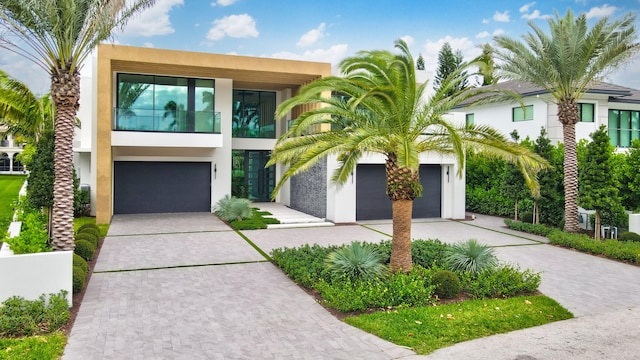 217 Thatch Palm Dr, Boca Raton, FL 33432 - view of front of home with stucco siding, a garage, and driveway