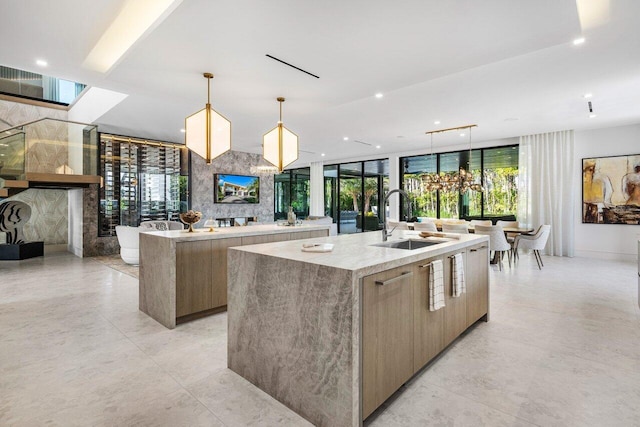 217 Thatch Palm Dr, Boca Raton, FL 33432 - kitchen with a large island, a sink, modern cabinets, a fireplace, and recessed lighting