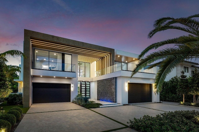 217 Thatch Palm Dr, Boca Raton, FL 33432 - modern home with a balcony, stucco siding, decorative driveway, and an attached garage