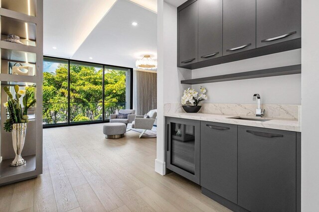 217 Thatch Palm Dr, Boca Raton, FL 33432 - indoor wet bar with floor to ceiling windows, wine cooler, light wood-style floors, and recessed lighting