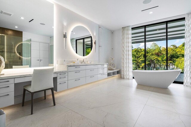 217 Thatch Palm Dr, Boca Raton, FL 33432 - full bathroom with a freestanding bath, vanity, floor to ceiling windows, and recessed lighting