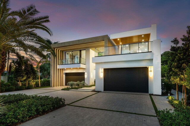 217 Thatch Palm Dr, Boca Raton, FL 33432 - modern home featuring a balcony, stucco siding, an attached garage, and decorative driveway