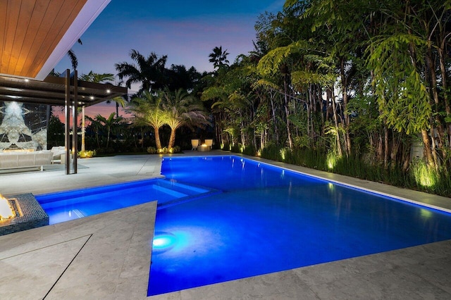 217 Thatch Palm Dr, Boca Raton, FL 33432 - pool at dusk featuring a patio area and a pool with connected hot tub