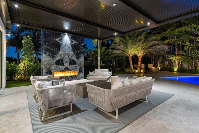 217 Thatch Palm Dr, Boca Raton, FL 33432 - patio at night with an outdoor living space with a fireplace and an outdoor pool
