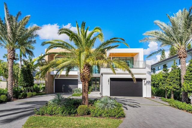 217 Thatch Palm Dr, Boca Raton, FL 33432 - view of front of property featuring driveway, a garage, stucco siding, and a balcony