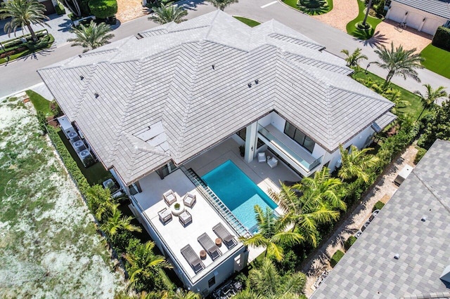 aerial view of property and surrounding area with a pool area