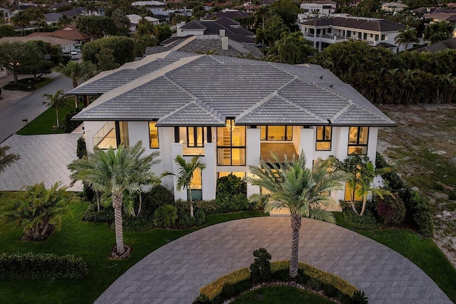 view of front of home with stucco siding and a tile roof
