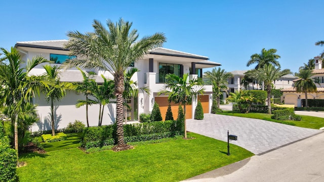 2498 Queen Palm Rd, Boca Raton, FL 33432 - view of front facade with driveway, a front lawn, and stucco siding