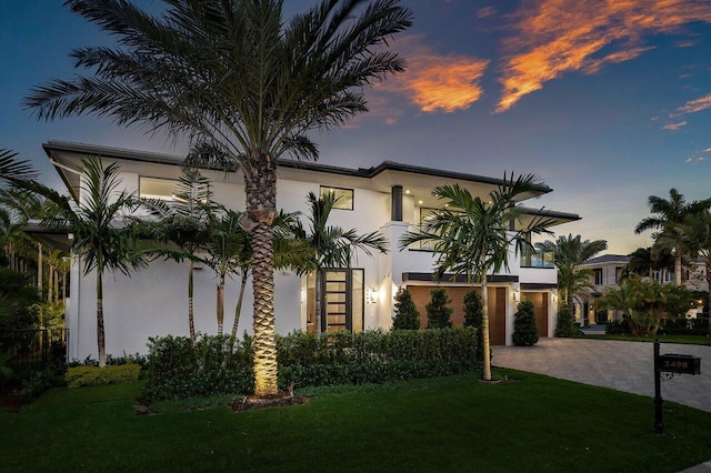 2498 Queen Palm Rd, Boca Raton, FL 33432 - view of front of home with stucco siding, decorative driveway, and a front yard