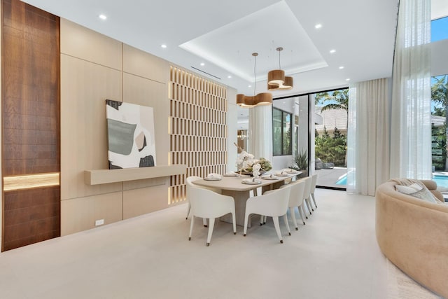 2498 Queen Palm Rd, Boca Raton, FL 33432 - dining room with healthy amount of natural light, expansive windows, a raised ceiling, and recessed lighting