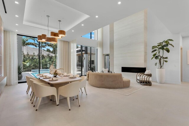 2498 Queen Palm Rd, Boca Raton, FL 33432 - dining area with plenty of natural light, recessed lighting, expansive windows, a fireplace, and a high ceiling