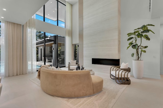 2498 Queen Palm Rd, Boca Raton, FL 33432 - living room featuring a towering ceiling, a high end fireplace, and recessed lighting