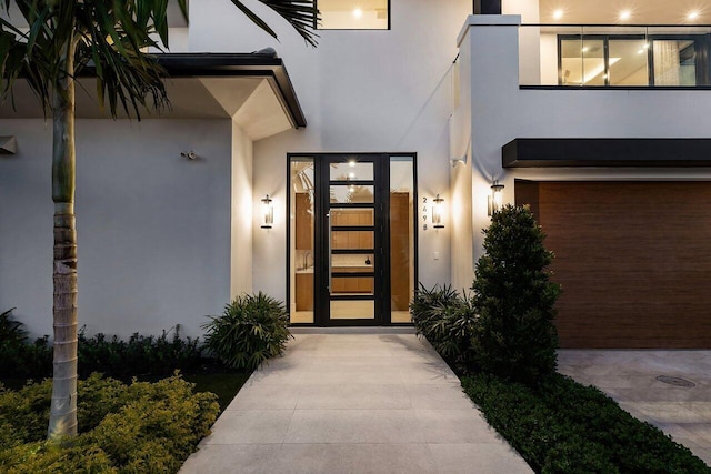 entrance to property featuring stucco siding