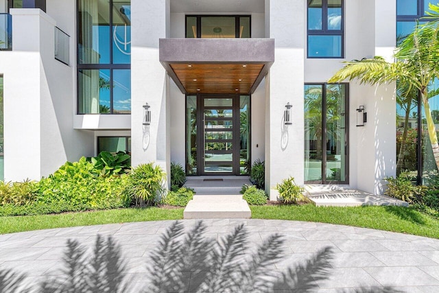 entrance to property featuring stucco siding