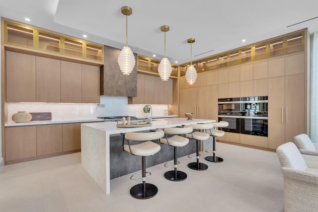 2498 Queen Palm Rd, Boca Raton, FL 33432 - kitchen featuring modern cabinets, backsplash, a breakfast bar, a kitchen island with sink, and recessed lighting