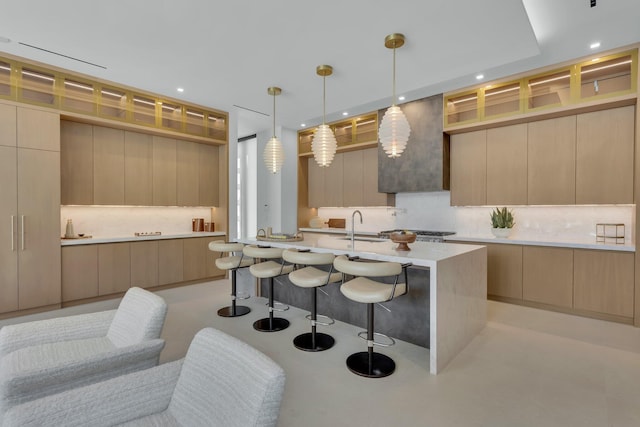 2498 Queen Palm Rd, Boca Raton, FL 33432 - kitchen with modern cabinets, backsplash, a breakfast bar area, light countertops, and a center island with sink