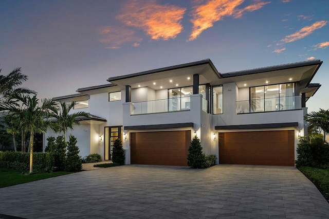 2498 Queen Palm Rd, Boca Raton, FL 33432 - contemporary home featuring a balcony, stucco siding, a garage, and decorative driveway