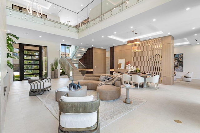 lobby with stairs, recessed lighting, and a high ceiling
