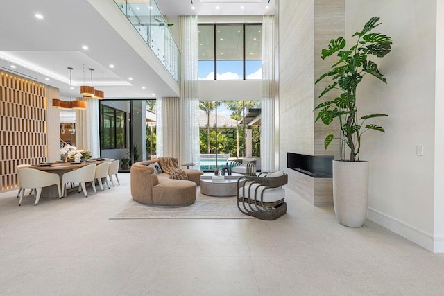 2498 Queen Palm Rd, Boca Raton, FL 33432 - living area featuring a high ceiling, a fireplace, recessed lighting, and a tray ceiling