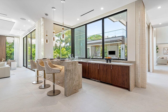 bar featuring expansive windows, hanging light fixtures, and recessed lighting